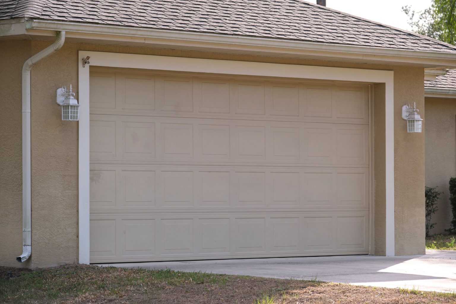 wide-garage-double-door-and-concrete-driveway-of-new-modern-american-house-1-1536x1024