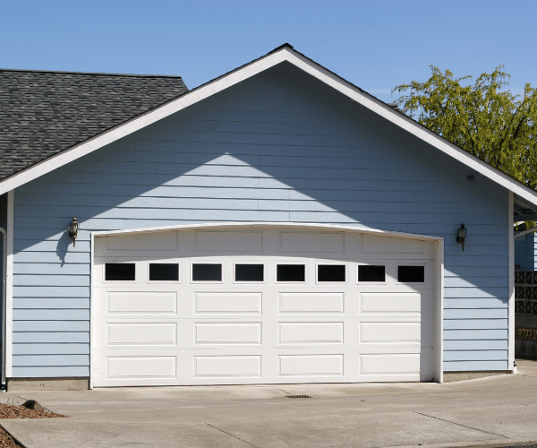 Garage door repair technicians replacing a broken spring in San Leandro