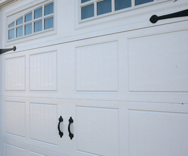 Garage door repair technicians replacing a broken spring in Berkeley