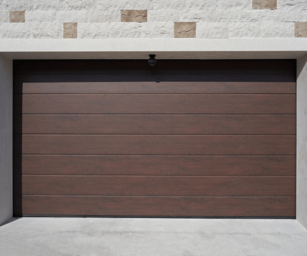 Garage door repair technicians replacing a broken spring in San Leandro