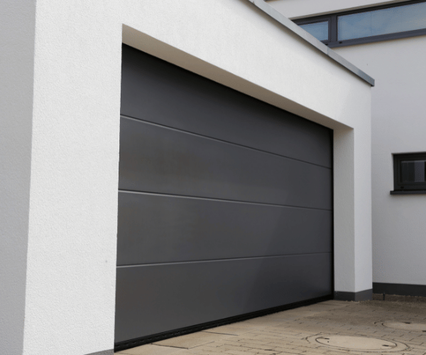 Garage door repair technicians replacing a broken spring in Pacifica