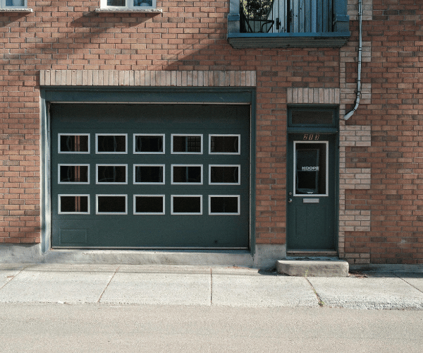 Garage door repair technicians replacing a broken spring in Richmond