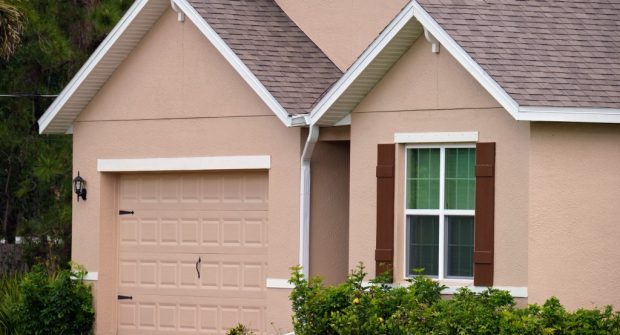 Garage door repair technicians replacing a broken spring in San&nbsp;Mateo
